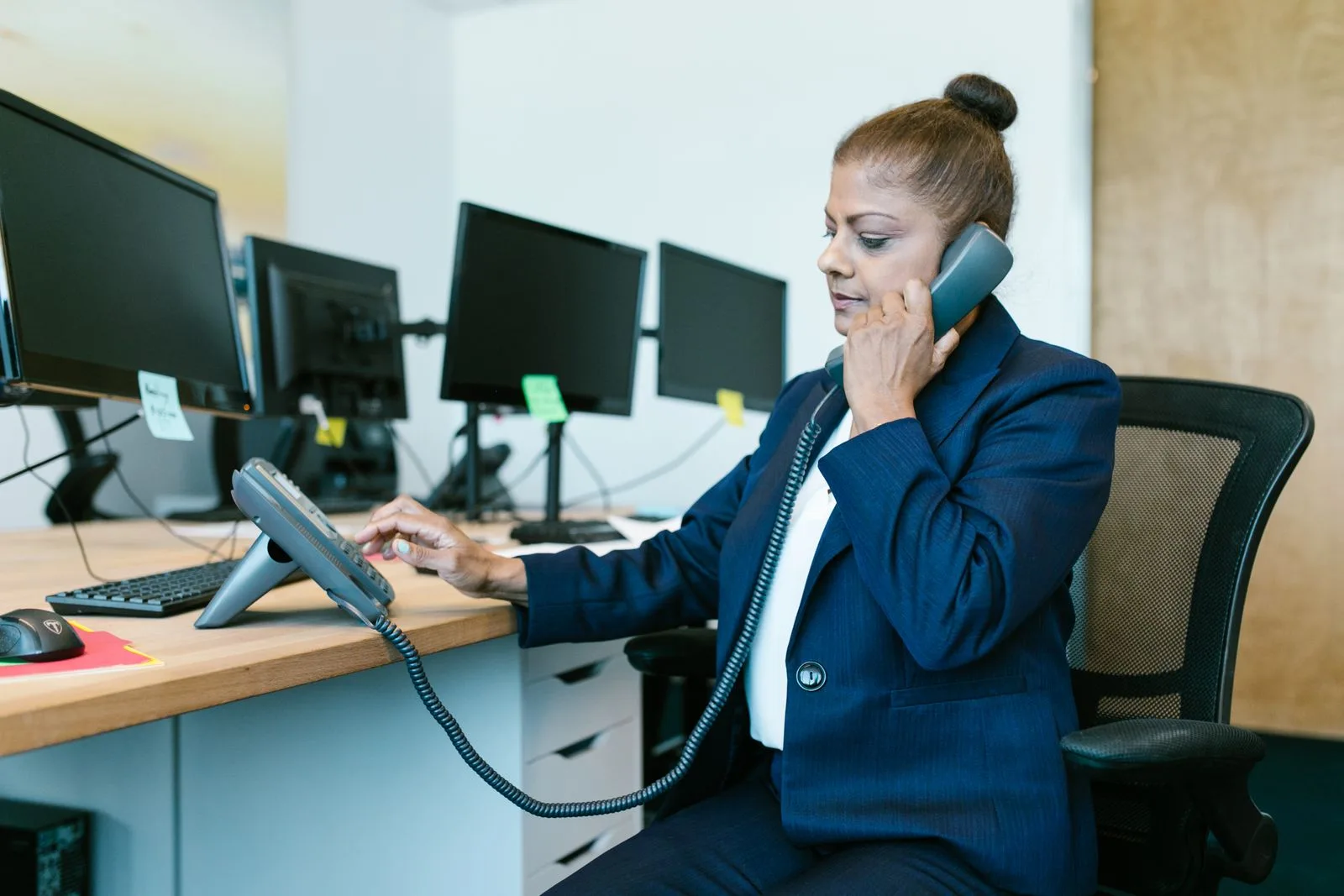 Business phone and communication equipment on a professional desk