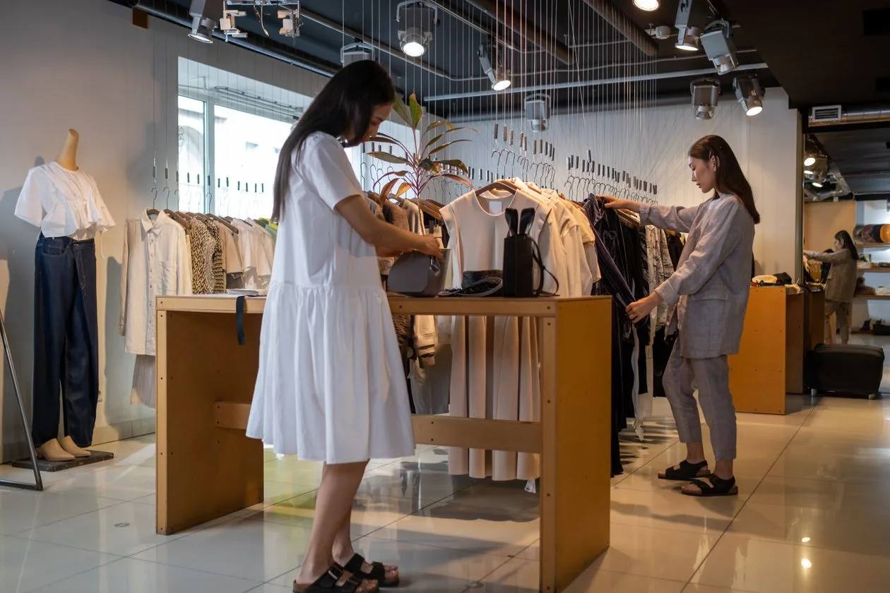 Shoppers browsing apparel in a modern clothing store