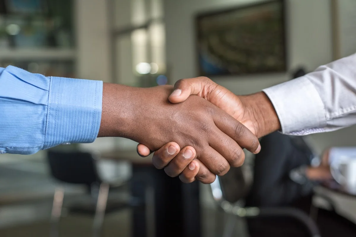 Business handshake representing expert support