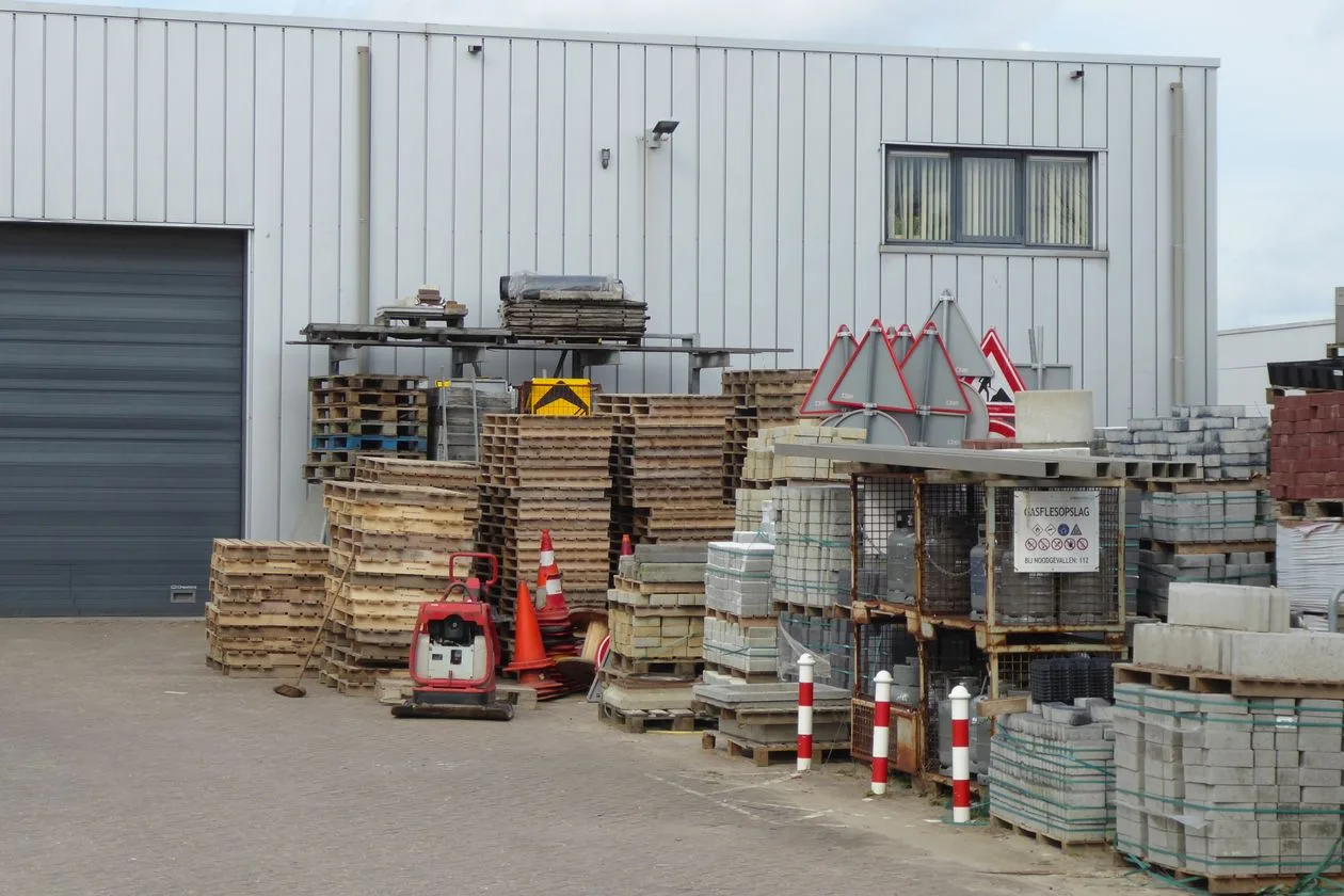 Pallets of pavers and block stacked in a landscape supply yard