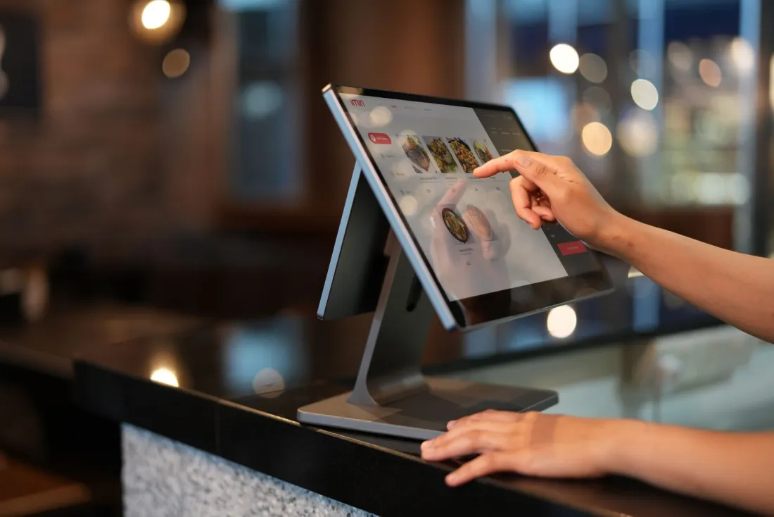 Retail associate using a POS touchscreen