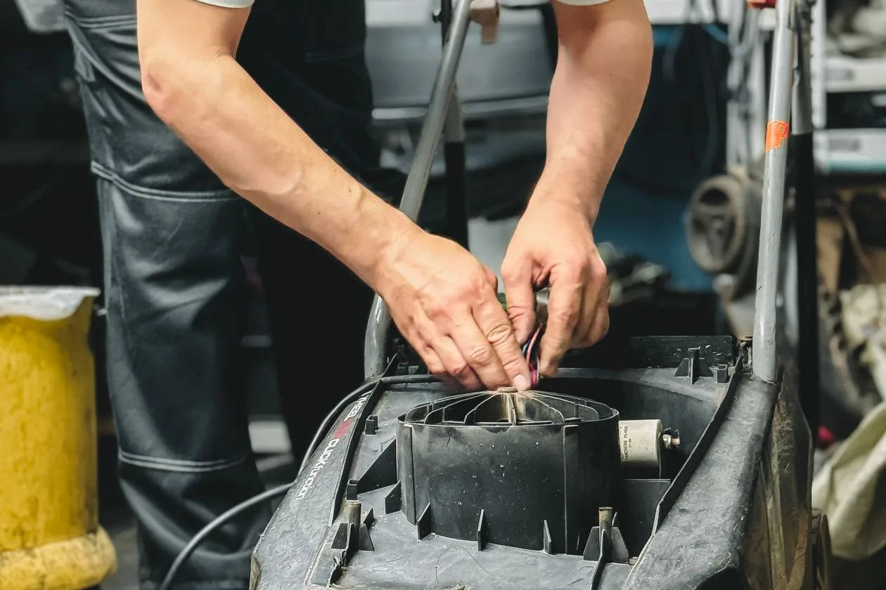 Service technician working on outdoor power equipment